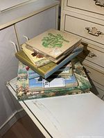 stack of wooden flower press and multiple boxed stationery sets