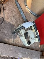 Left side view showing full chainsaw body and bar