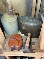 Group shot showing jug, brass container, wooden puzzle box, bacon press