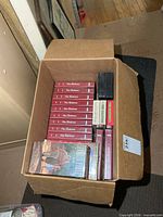 Box overview showing quantity and variety of VHS tapes