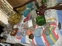 Overall lot showing multiple glass pieces on table
