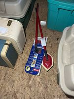 Both floor cleaners on floor, boxed unit and loose scrub mop visible