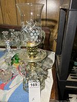 Full view of glass electric lamp with etched chimney and crystal prisms