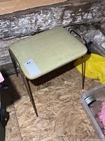 Overall view of stool showing seat and metal frame