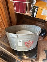 Front view of galvanized washtub with enamel bowl inside