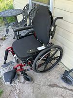 Full view of red Invacare Patriot wheelchair with footrests