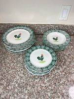 Stacked dinner plates and soup/pasta bowls with rooster motif