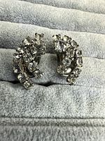 Front view of both LaRel rhinestone clip-on earrings on display pad