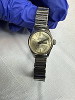 Front view of watch showing dial, hands, bracelet