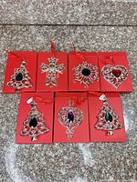 All seven boxed Lenox ornaments laid out