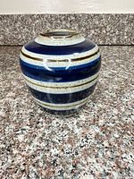 Front view of striped stoneware vase