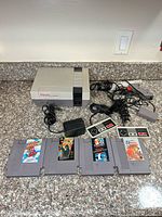 Overall lot: console, controllers, Zapper, power adapter, RF/AV switch, four game cartridges