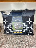Pendleton blanket in folded carry case showing pattern and hangtag