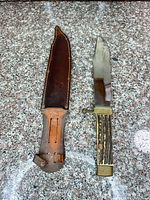 Knife and sheath full view on granite surface