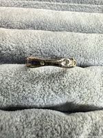 Front view of tarnished sterling silver band with CZ stones