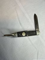 Knife open showing handle, shield, bail