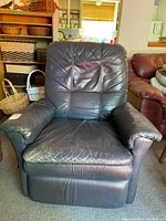Front view of black leather La-Z-Boy recliner showing overall design and wear