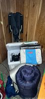Open Koolatron cooler with accessories, Outbound cooler bag, sleeping bag, folded chair visible