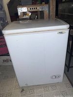 Front exterior view of white Danby Millennium chest freezer showing control knob and brand label