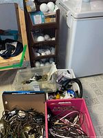 Overview of bins with bulbs, faceplates, hardware and wiring