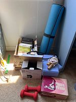 Group shot of all items: yoga mat, blocks, dumbbells, DVDs box, ankle weights box, jump rope, Scandia Figure Firmer