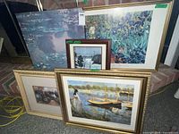 Group shot of all five framed prints leaning against wall