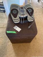 Foot massager resting on ottoman showing both items together