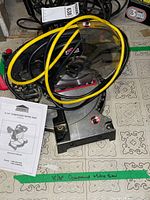Top view showing saw, blade guard, coiled power cord and instruction manual