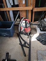 Front view of Jobmate vacuum with hose and wand pieces