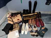 Overview of all shoes, bags, hat and case on floor