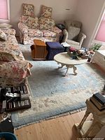 Full room view showing entire rug under furniture