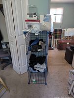 Full view of tower with Omron monitor box on top and multiple braces on shelves