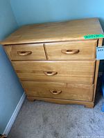 Front view of dresser showing four drawers and integrated handles