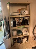 Full view of beige four-tier plastic shelving unit with items on it (items not included)