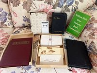 Group shot of all books, memorial booklet, box of cards