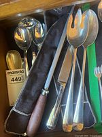 group shot of all Heritage silver-tone serving utensils in cloth case