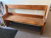 Front angled view of full wooden bench
