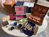 Overall lot view showing jewellery boxes, manicure set, stone dish and decorative items on table