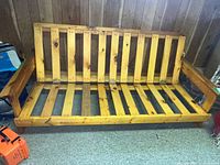 Front view of wooden slatted futon frame
