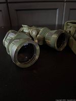 Front view of binocular objectives showing Bushnell logo