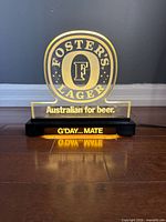 Front view showing illuminated Foster's Lager logo and G'DAY... MATE text