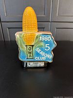Front view showing Iowa shape, corn stopper, "1980 5 Seasons Club" text and base label