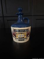 Front view of Lamb's Navy Rum ceramic decanter showing label and overall form