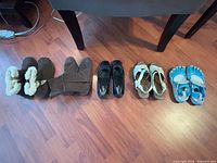 Five pairs of shoes lined up on floor