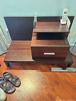 Front view showing nightstand design, drawers, shelf