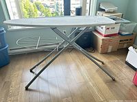 Full view of ironing board unfolded showing frame and drying rack