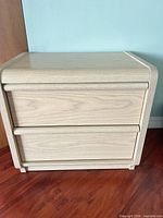 full frontal view of nightstand showing two drawers and finish
