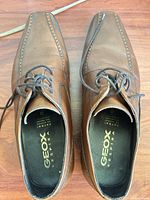 Top view of both Geox brown leather derby shoes, laces visible