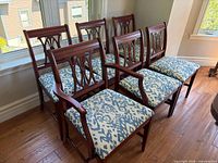 six wooden dining chairs lined together
