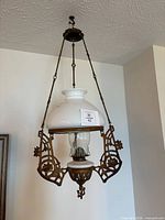 Full view of hanging brass and glass oil chandelier
